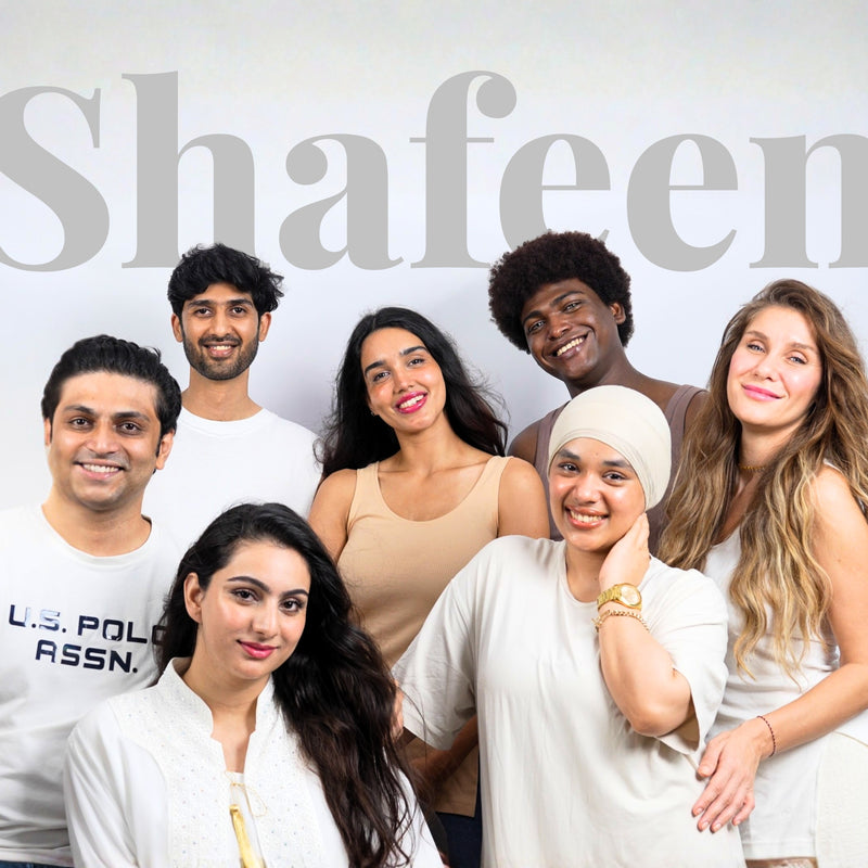 Group of models posing together along with c-founder of 'Shafeen' with branding in the background