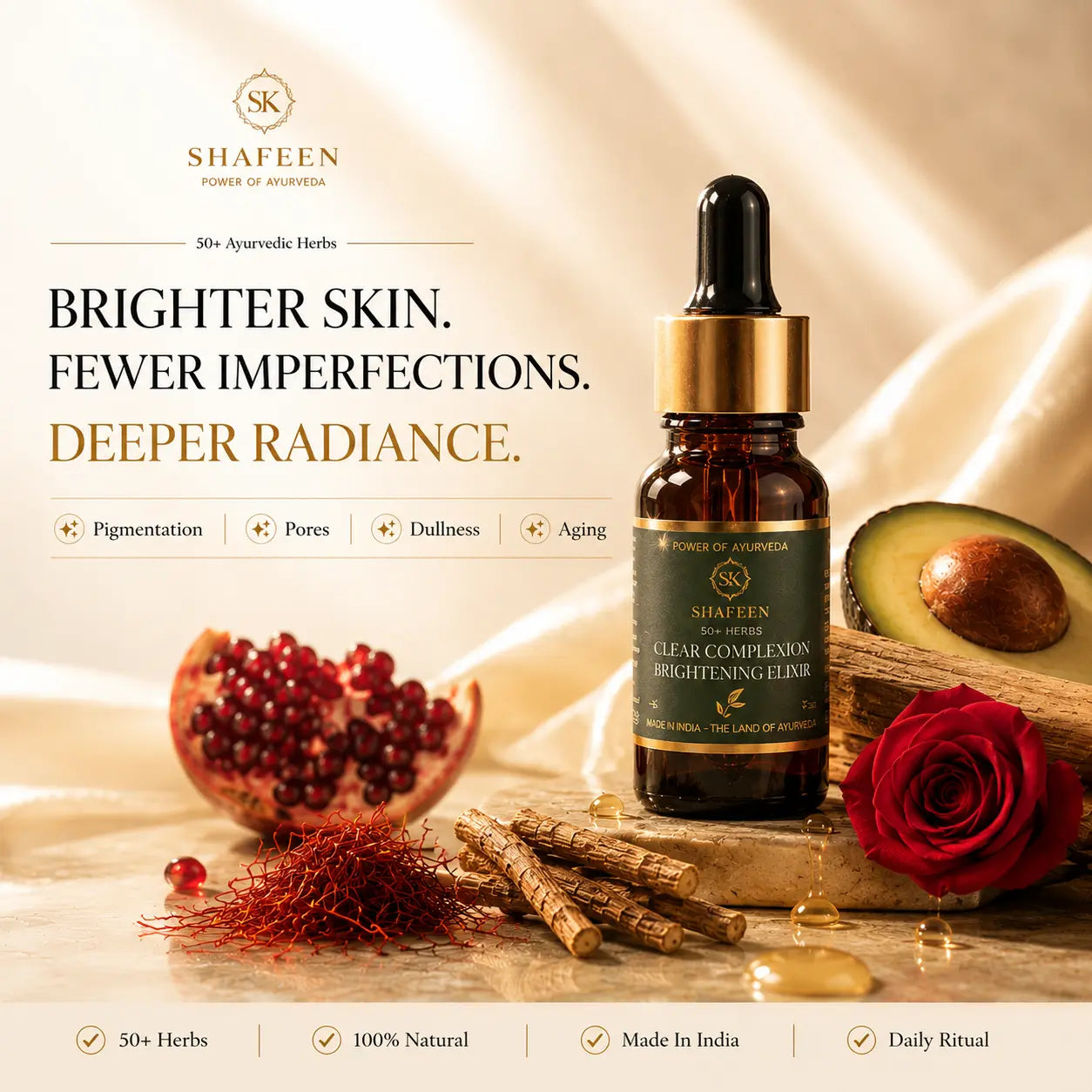 Shafeen Ayurveda Clear Complexion Brightening Elixir in an amber glass dropper bottle, styled with a pomegranate, avocado, red rose, and herbal roots on a draped beige fabric background with promotional text.