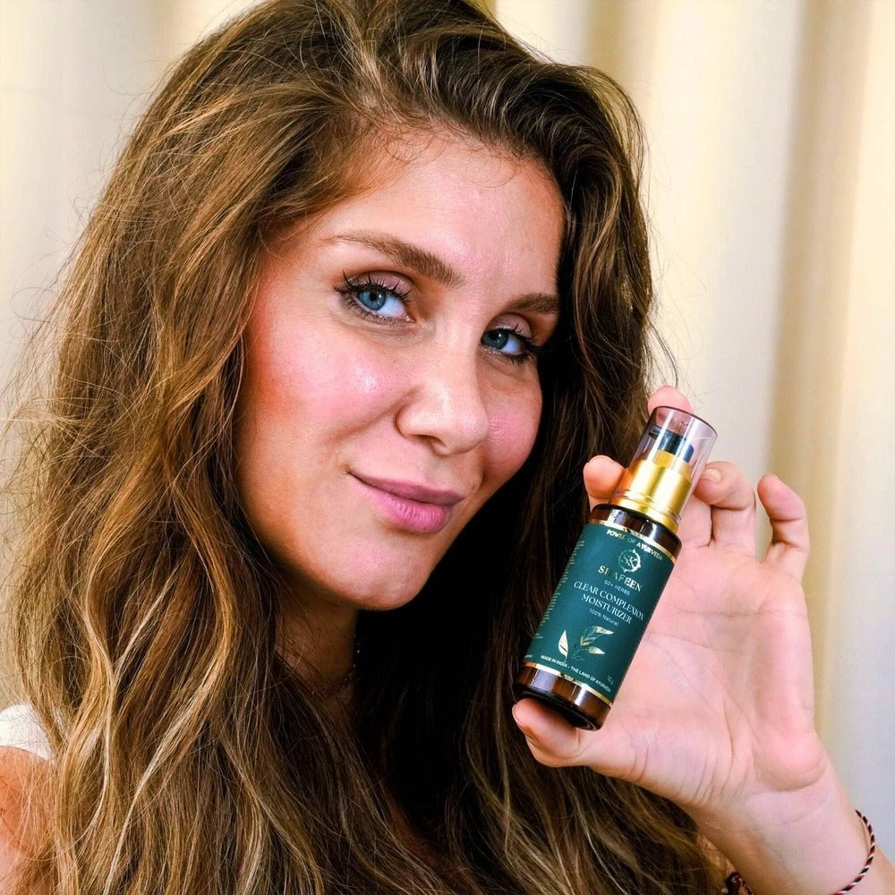 Woman holding a skincare serum bottle with a blurred background